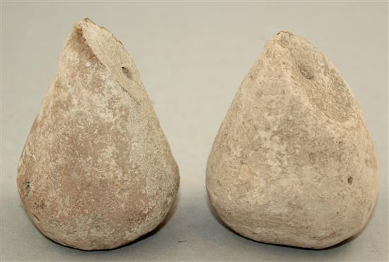 A pair of Greek stone loom weights, c.3rd century BC, 8.5cm and 9.5cm